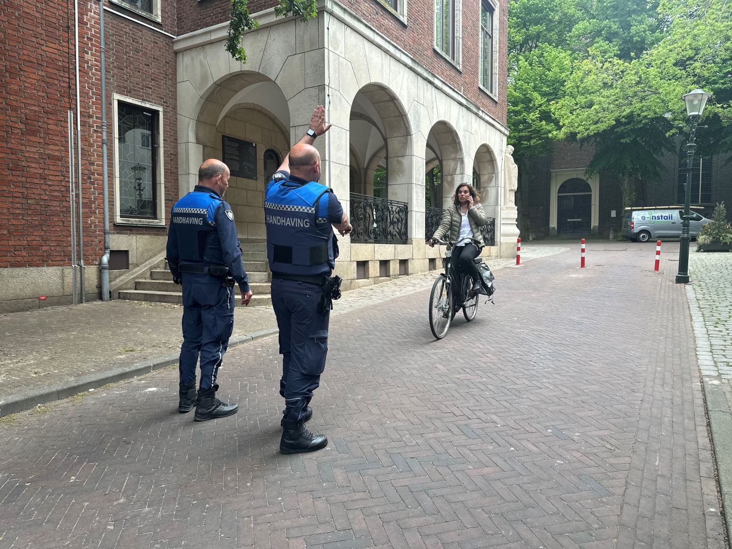 Toezicht & Handhaving houden een fietser staande vanwege het bellen op de fiets